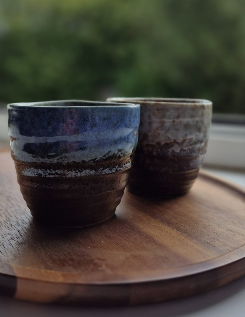 Handpainted glazed ceramic tea cups set in blue and white 